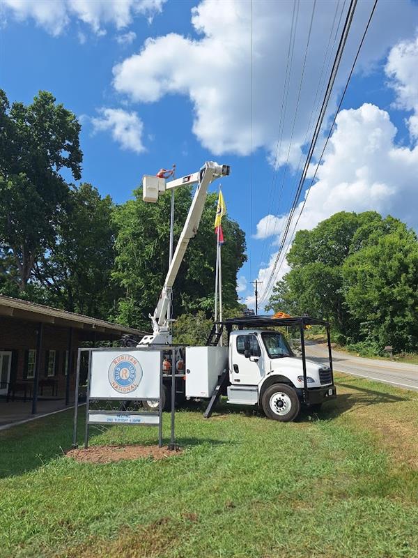 Bark Busters hanging the American Flag at the Harrison Ruritan Club